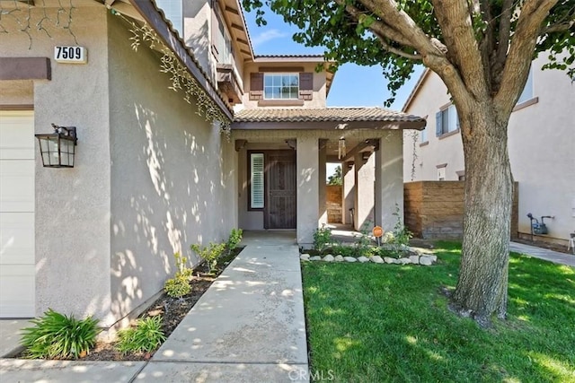 7509 Woodstream Ct, Rancho Cucamonga, CA 91739 - entrance to property featuring stucco siding, a tile roof, and an attached garage