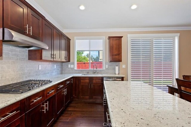 7509 Woodstream Ct, Rancho Cucamonga, CA 91739 - kitchen with under cabinet range hood, stainless steel appliances, crown molding, dark wood-type flooring, and light stone counters