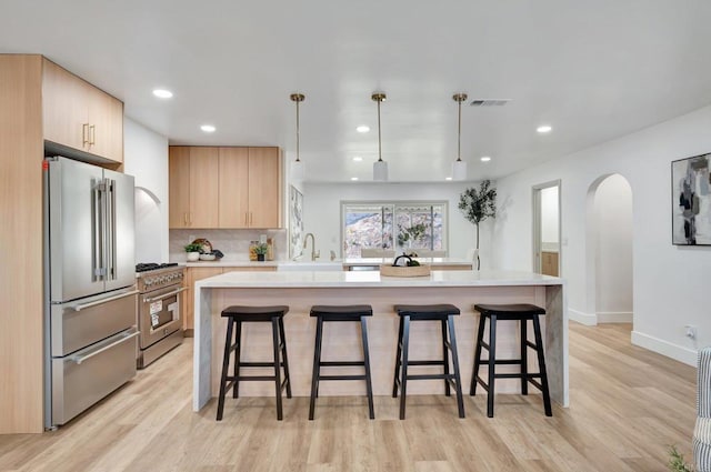 1665 Yale St, Chula Vista, CA 91913 - kitchen with high quality appliances, light brown cabinets, light countertops, a breakfast bar, and recessed lighting