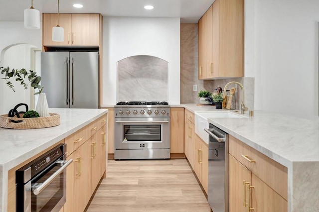 1665 Yale St, Chula Vista, CA 91913 - kitchen featuring appliances with stainless steel finishes, light brown cabinetry, light stone counters, light wood-style flooring, and recessed lighting