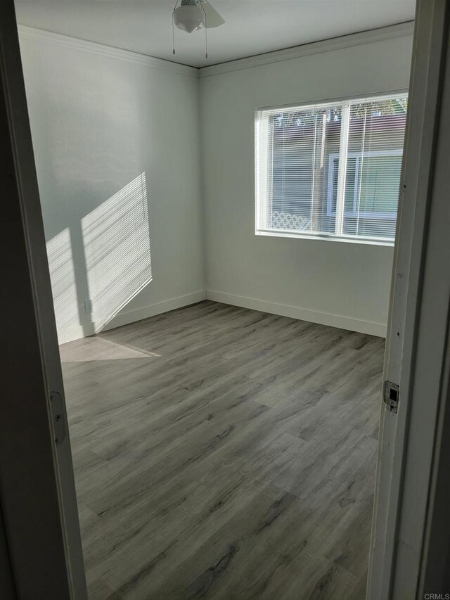 3222 42nd St, San Diego, CA 92105 - spare room with wood finished floors, crown molding, and a ceiling fan
