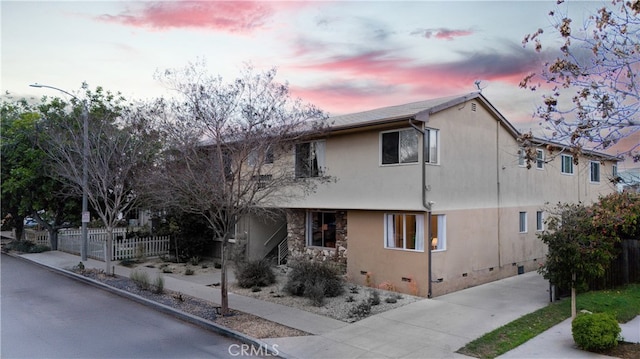 2135 E Florida St Unit 2, Long Beach, CA 90814 - property exterior at dusk with crawl space, stucco siding, and stone siding