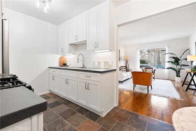 2135 E Florida St Unit 2, Long Beach, CA 90814 - kitchen featuring decorative backsplash, white cabinetry, stone tile floors, and gas range oven
