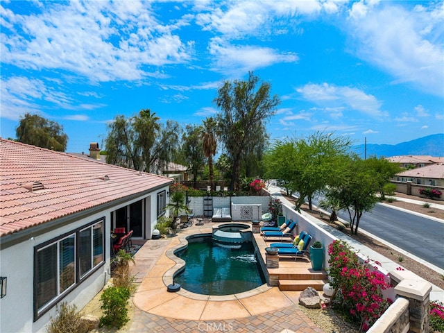 43875 Spiaggia Pl, Indio, CA 92203 - view of swimming pool with a mountain view, a pool with connected hot tub, and a patio area