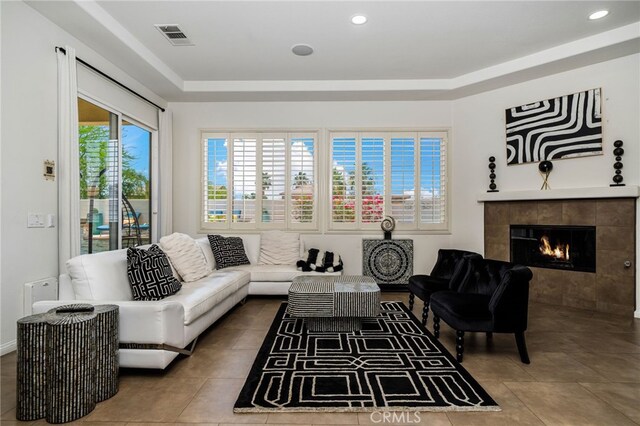 43875 Spiaggia Pl, Indio, CA 92203 - tiled living room with a fireplace, recessed lighting, and a tray ceiling