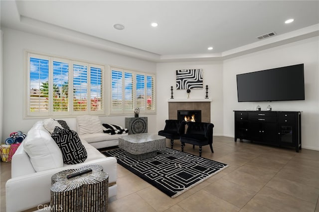 43875 Spiaggia Pl, Indio, CA 92203 - tiled living room featuring recessed lighting, a raised ceiling, and a tile fireplace