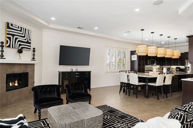 43875 Spiaggia Pl, Indio, CA 92203 - living area featuring recessed lighting, light tile patterned floors, and a tiled fireplace