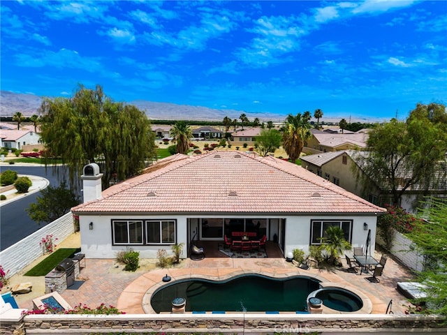 43875 Spiaggia Pl, Indio, CA 92203 - rear view of house featuring stucco siding, a mountain view, a tiled roof, and a patio