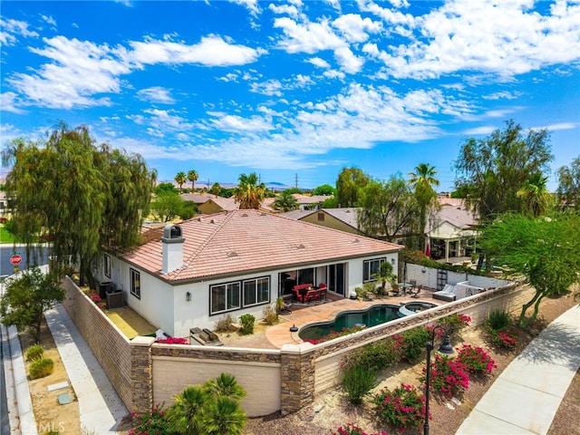 43875 Spiaggia Pl, Indio, CA 92203 - rear view of house featuring a tiled roof, stucco siding, a fenced backyard, and a garage