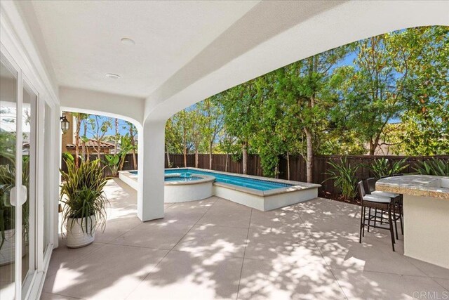 7147 Sitio Bahia, Carlsbad, CA 92009 - fenced backyard featuring a hot tub and a patio