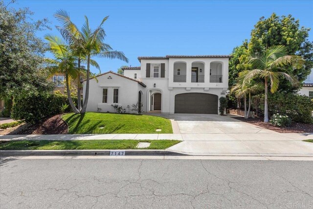 7147 Sitio Bahia, Carlsbad, CA 92009 - mediterranean / spanish home with a balcony, a garage, concrete driveway, stucco siding, and a front yard