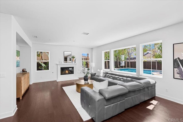 7147 Sitio Bahia, Carlsbad, CA 92009 - living area featuring dark wood-type flooring and a glass covered fireplace