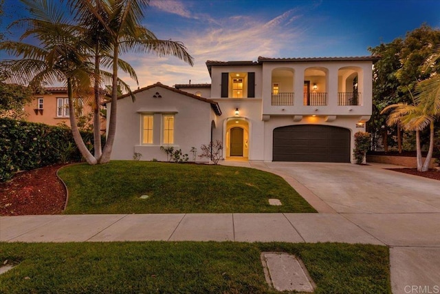 7147 Sitio Bahia, Carlsbad, CA 92009 - mediterranean / spanish-style home featuring an attached garage, stucco siding, a balcony, concrete driveway, and a front lawn