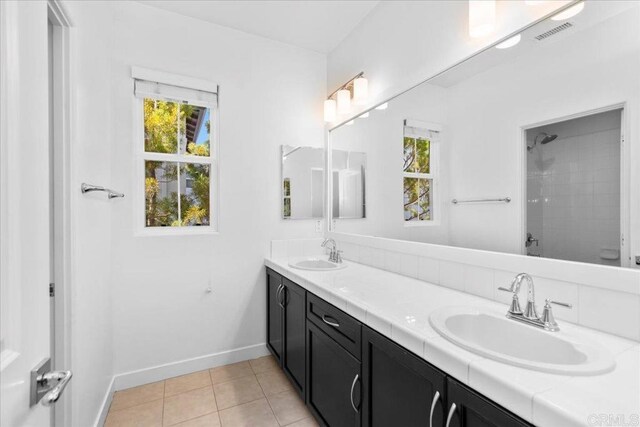 7147 Sitio Bahia, Carlsbad, CA 92009 - bathroom with double vanity, tile patterned floors, and a shower