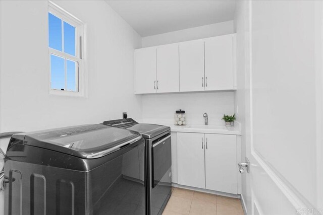 7147 Sitio Bahia, Carlsbad, CA 92009 - laundry room with washer and clothes dryer, cabinet space, and light tile patterned floors