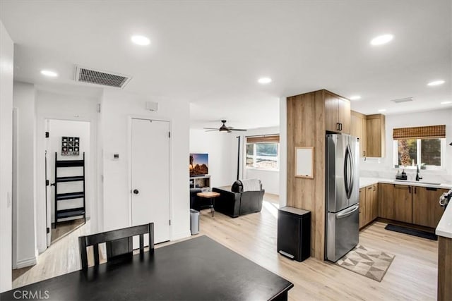 7227 Sherman Hoyt Ave Unit 29, Palms, CA 92277 - kitchen featuring freestanding refrigerator, plenty of natural light, light wood finished floors, ceiling fan, and recessed lighting