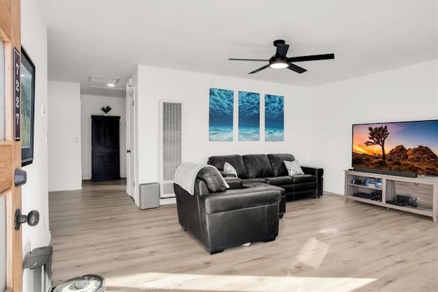 7227 Sherman Hoyt Ave Unit 29, Palms, CA 92277 - living area featuring a heating unit, light wood-style flooring, a ceiling fan, and attic access