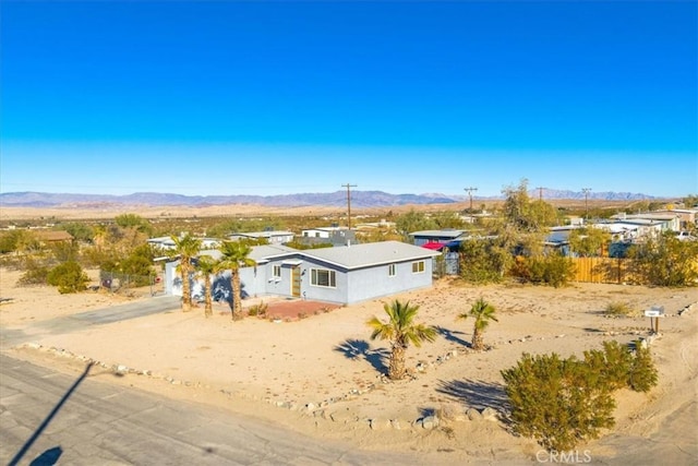 7227 Sherman Hoyt Ave Unit 29, Palms, CA 92277 - single story home featuring a mountain view, dirt driveway, a garage, and view of desert
