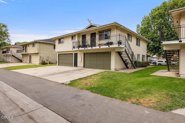 656 W Hemlock St, Port Hueneme, CA 93041 - multi unit property with stairs, stucco siding, an attached garage, a front yard, and concrete driveway