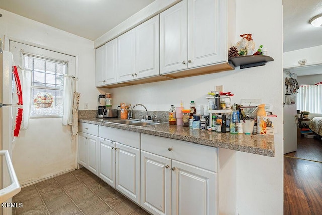 656 W Hemlock St, Port Hueneme, CA 93041 - kitchen featuring white cabinets and freestanding refrigerator