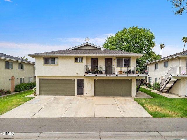656 W Hemlock St, Port Hueneme, CA 93041 - view of front of home featuring stucco siding, an attached garage, stairs, concrete driveway, and a balcony