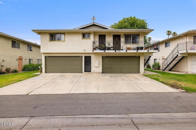 656 W Hemlock St, Port Hueneme, CA 93041 - view of front of home featuring stucco siding, an attached garage, concrete driveway, stairs, and a balcony