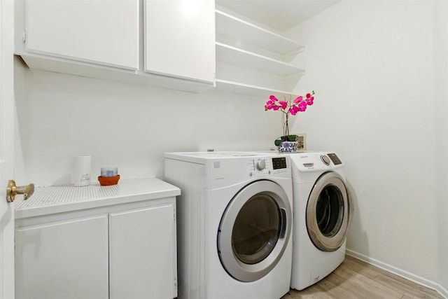 2344 Greenbriar Dr Unit A, Chula Vista, CA 91915 - washroom with washing machine and clothes dryer, light wood-style flooring, and cabinet space