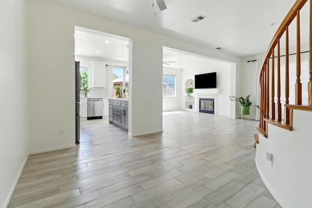 2344 Greenbriar Dr Unit A, Chula Vista, CA 91915 - unfurnished living room with ceiling fan, light wood finished floors, a fireplace, and stairway