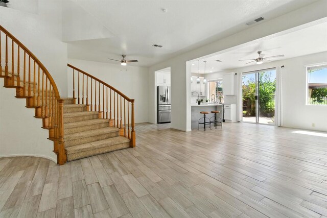 2344 Greenbriar Dr Unit A, Chula Vista, CA 91915 - unfurnished living room featuring a ceiling fan, light wood-style floors, and stairs