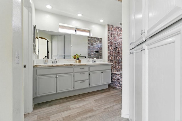 2344 Greenbriar Dr Unit A, Chula Vista, CA 91915 - bathroom with double vanity, wood finished floors, and a shower with curtain