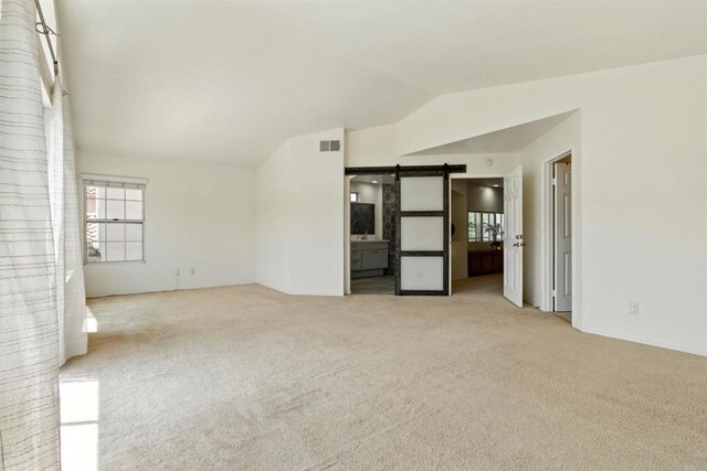 2344 Greenbriar Dr Unit A, Chula Vista, CA 91915 - spare room with vaulted ceiling, carpet flooring, and a barn door