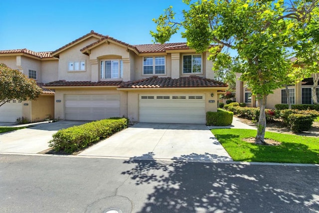 2344 Greenbriar Dr Unit A, Chula Vista, CA 91915 - view of property with stucco siding, a garage, a tile roof, and driveway