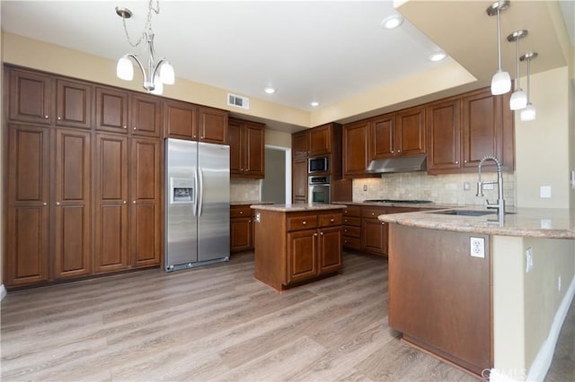 30528 Covecrest Cir, Menifee, CA 92584 - kitchen with stainless steel appliances, under cabinet range hood, light wood-style flooring, backsplash, and light stone counters