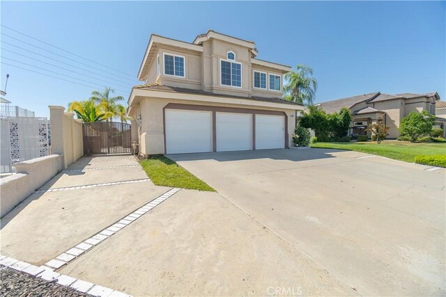 30528 Covecrest Cir, Menifee, CA 92584 - traditional-style house with stucco siding, an attached garage, concrete driveway, and a gate