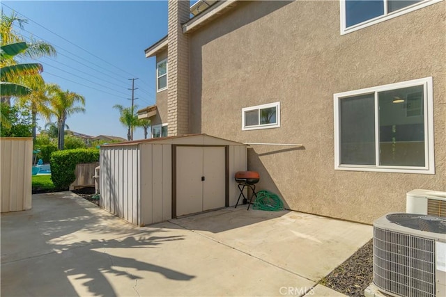 30528 Covecrest Cir, Menifee, CA 92584 - view of home's exterior with a patio, a storage unit, and stucco siding