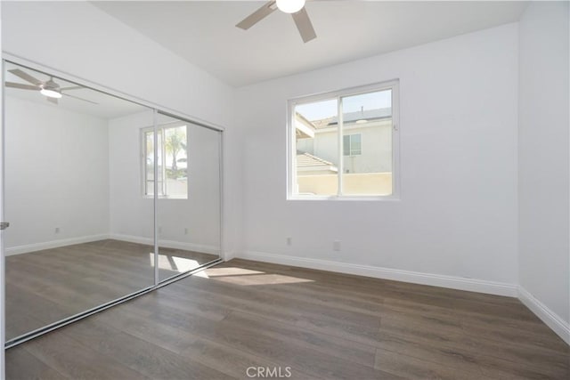 30528 Covecrest Cir, Menifee, CA 92584 - unfurnished bedroom featuring multiple windows, wood finished floors, a closet, and ceiling fan