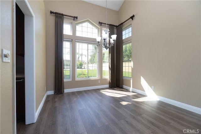 30528 Covecrest Cir, Menifee, CA 92584 - unfurnished dining area with a chandelier, wood finished floors, and a high ceiling