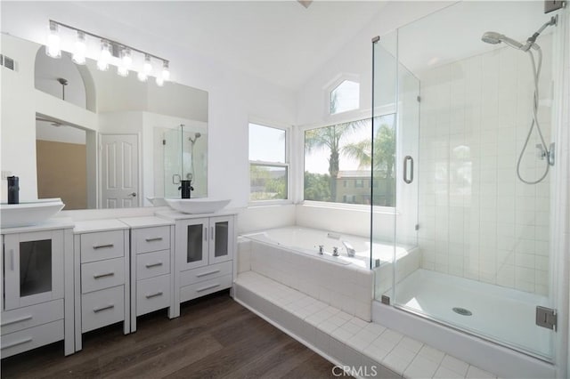 30528 Covecrest Cir, Menifee, CA 92584 - bathroom featuring vaulted ceiling, double vanity, a stall shower, and a bath