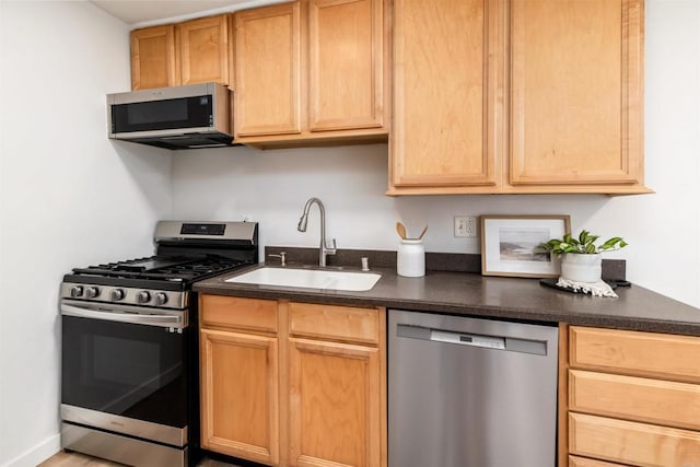 13754 Mango Dr Unit 111, Del Mar, CA 92014 - kitchen with appliances with stainless steel finishes and dark countertops