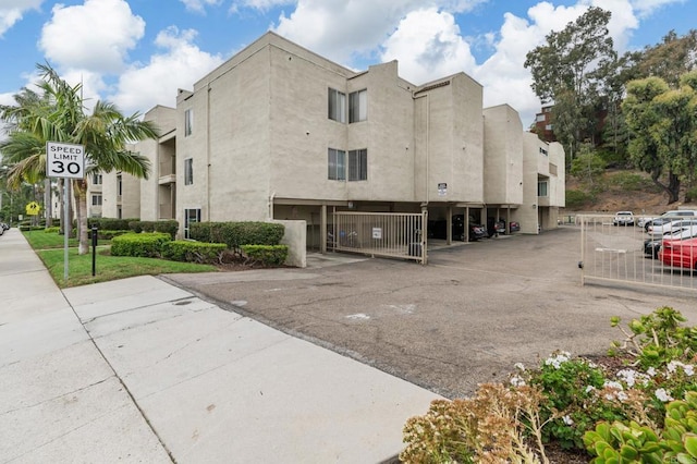 13754 Mango Dr Unit 111, Del Mar, CA 92014 - view of building exterior featuring uncovered parking
