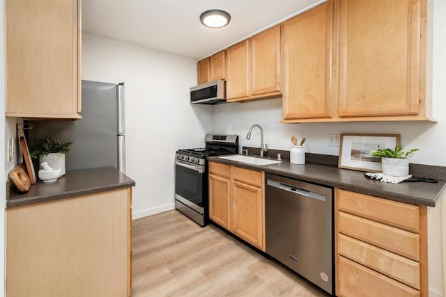 13754 Mango Dr Unit 111, Del Mar, CA 92014 - kitchen with stainless steel appliances, dark countertops, and light brown cabinetry
