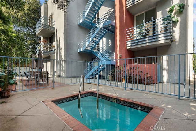 5151 Balboa Blvd Unit 303, Encino, CA 91316 - view of swimming pool with an outdoor hot tub, a patio area, outdoor dining area, and stairway