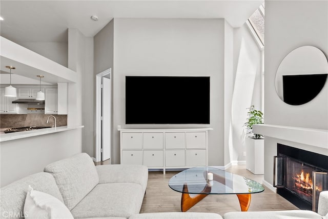 5151 Balboa Blvd Unit 303, Encino, CA 91316 - living area featuring light wood-style floors and a lit fireplace