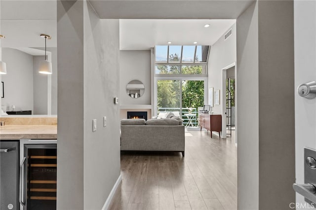 5151 Balboa Blvd Unit 303, Encino, CA 91316 - living area with wine cooler, wood finished floors, bar, a lit fireplace, and recessed lighting