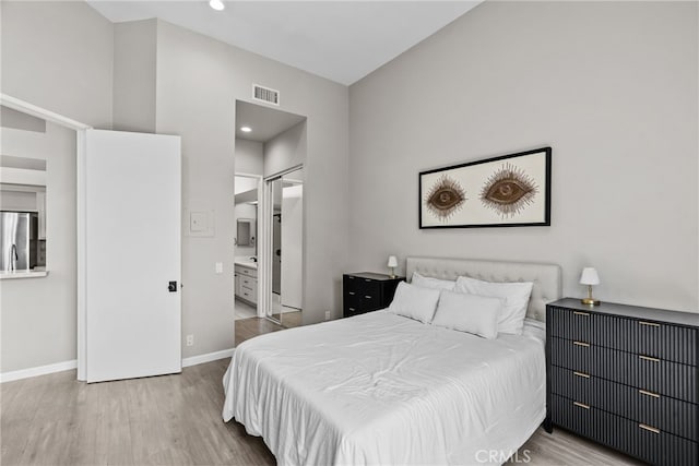 5151 Balboa Blvd Unit 303, Encino, CA 91316 - bedroom featuring stainless steel fridge, wood finished floors, recessed lighting, and ensuite bathroom