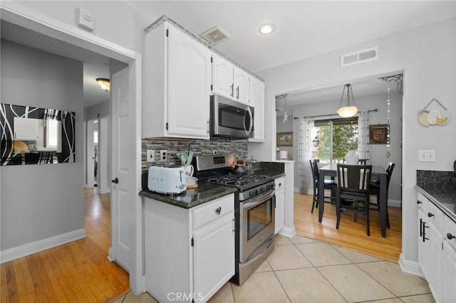 708 S Vecino Dr, Glendora, CA 91740 - kitchen featuring stainless steel appliances, white cabinets, decorative backsplash, light wood-style floors, and dark stone counters