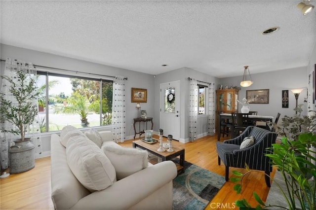 708 S Vecino Dr, Glendora, CA 91740 - living room with a textured ceiling, plenty of natural light, and light wood-style flooring