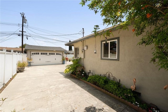 708 S Vecino Dr, Glendora, CA 91740 - view of side of home featuring stucco siding, an outdoor structure, and a garage