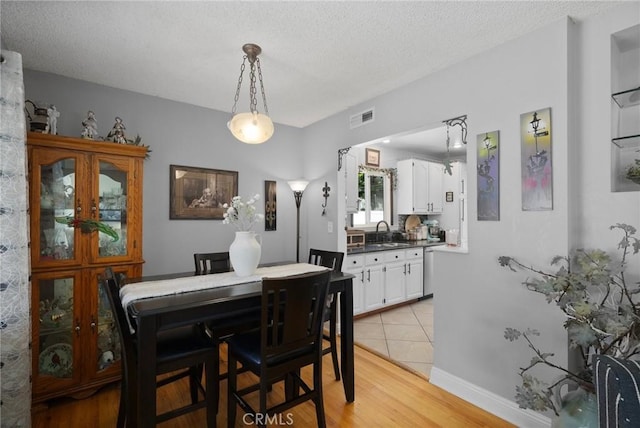 708 S Vecino Dr, Glendora, CA 91740 - dining space with light wood-style floors and a textured ceiling