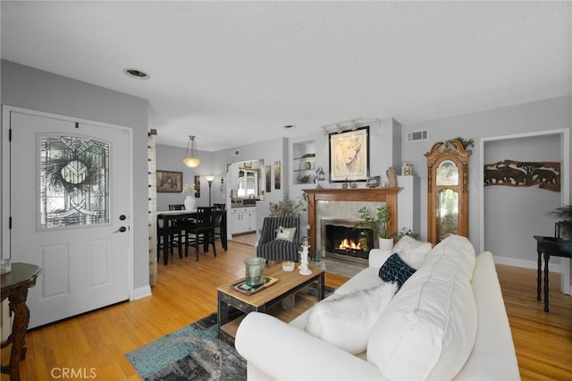 708 S Vecino Dr, Glendora, CA 91740 - living area with a lit fireplace and light wood finished floors
